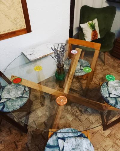 a glass table with a vase of flowers and a chair at Casa al mare in Sveti Juraj