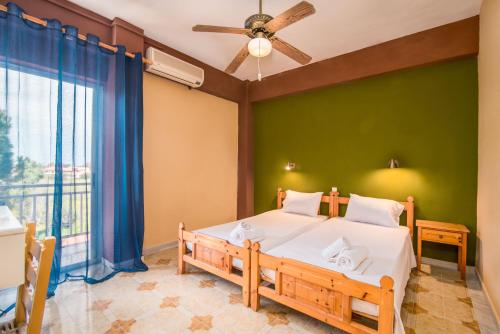 a bedroom with a bed and a green wall at Southgate Apartments in Agios Georgios