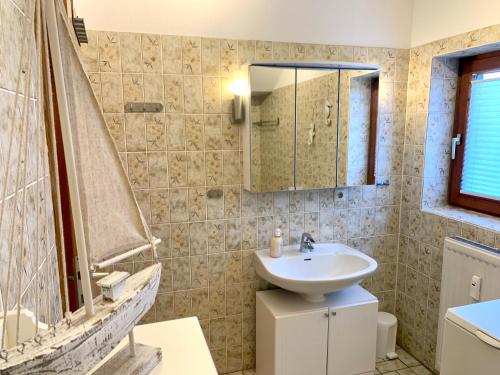 a bathroom with a sink and a mirror at Ferienwohnung "Laura" in Sankt Peter-Ording