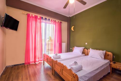 a bedroom with two beds with white towels on them at Southgate Apartments in Agios Georgios