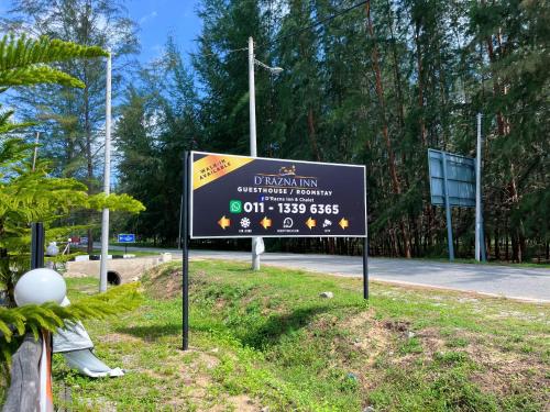 a sign on the side of a road at D’Razna Inn in Kuala Terengganu