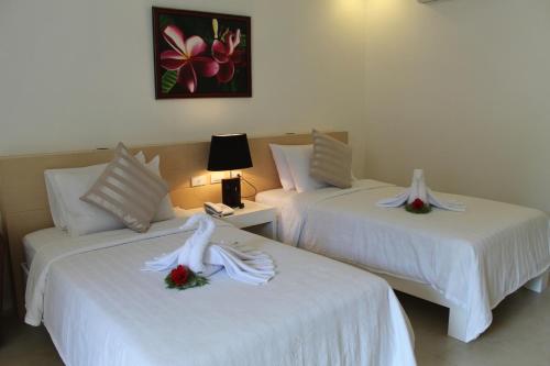 Ένα ή περισσότερα κρεβάτια σε δωμάτιο στο Casa Pilar Beach Resort