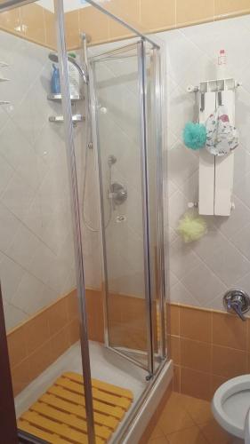 a shower with a glass door in a bathroom at Palazzo Nistico' in Soverato Marina