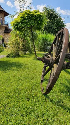 a statue of a cannon sitting in the grass at Hotel Do Poduchy in Zawiercie