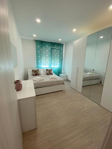 a bedroom with a bed and a mirror at Melitta apartment Giardini Naxos in Giardini Naxos