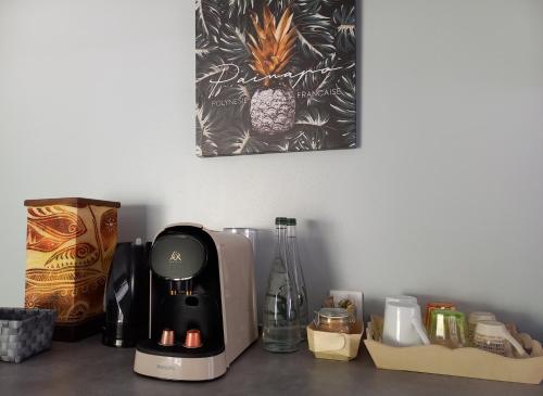 a coffee maker sitting on a counter with other items at Rava Lodge in Punaauia