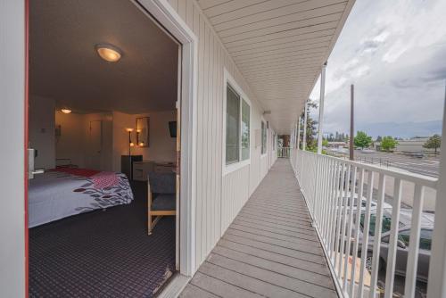 a porch of a house with a bedroom and a bed at Budget Inn Bend in Bend