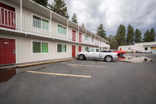 a white truck parked in front of a building at Budget Inn Bend in Bend