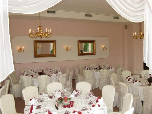 a set up for a wedding in a room with white tables and chairs at Schloss Herrenstein in Gerswalde