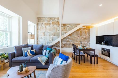 a living room with a blue couch and a table at Porto Loft Living in Porto