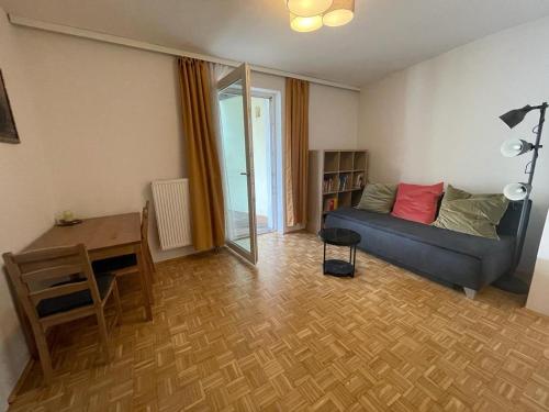 a living room with a couch and a table at Zentrum & Schöne Terasse in Graz