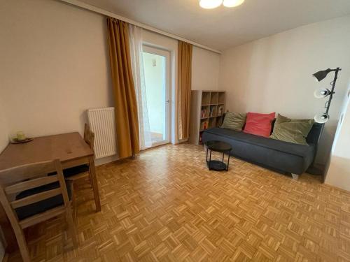 a living room with a couch and a table at Zentrum & Schöne Terasse in Graz