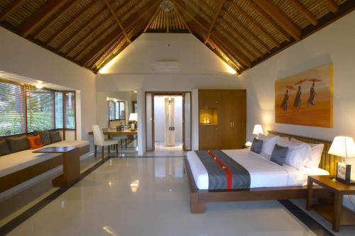 Postel nebo postele na pokoji v ubytování Siddhartha Oceanfront Resort & Spa Bali