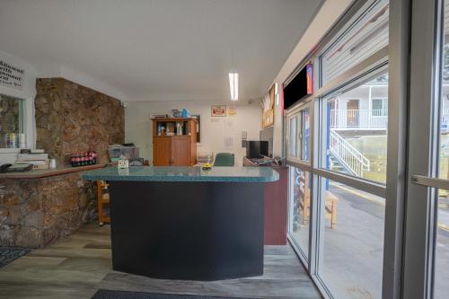 a kitchen with a counter in a room at Budget Inn Bend in Bend