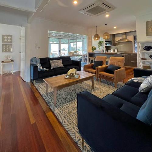 a living room with two couches and a coffee table at The Cove Cottage in Pemberton