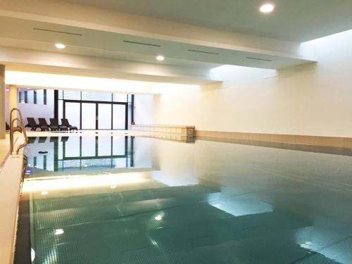 a swimming pool in a building with a poolasteryasteryasteryasteryasteryasteryastery at SKY9 Penthouse Apartments in Vienna
