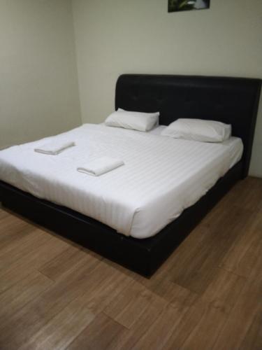 a bed with two white pillows on top of it at JAM Hotel Kota Warisan Sepang @ ERL Salak Tinggi, KLIA 1-2 & F1 in Sepang