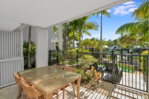 a patio with a table and chairs on a balcony at Salt&Pepper Sanctuary - Plunge Pool Resort Apartment by uHoliday - 2BR, 1BR and Studio Hotel Room configurations available in Kingscliff