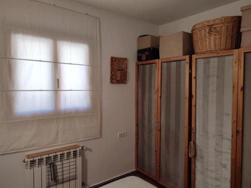 a living room with a window and a radiator at La Launa apartamento rural in Trevélez