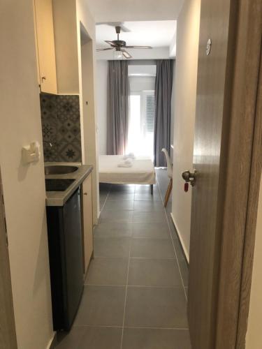 a hallway leading to a room with a bedroom at Ammos Hotel in Agia Triada