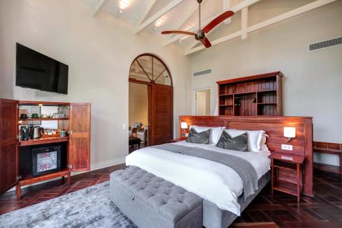 a bedroom with a bed and a flat screen tv at Palm River Hotel in Victoria Falls