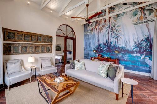 a living room with a couch and two chairs at Palm River Hotel in Victoria Falls
