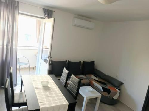 a living room with a couch and a table at Apartment "None" Makarska in Makarska