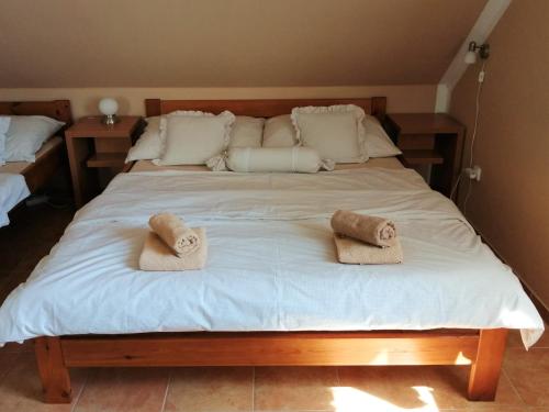 a large white bed with two towels on it at Slunečnice - Ubytování v soukromí na Třeboňsku in Třeboň