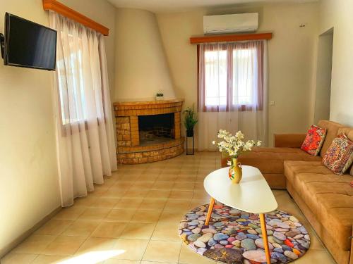 a living room with a couch and a fireplace at house with sea and mountain view in Rozená