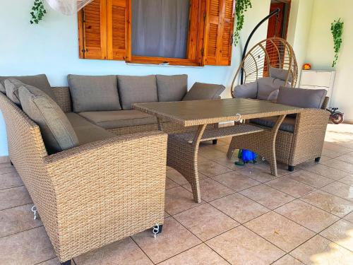 a table and chairs and a couch and a table at house with sea and mountain view in Rozená