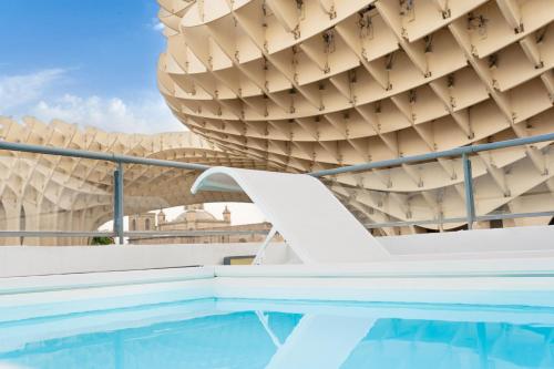 a swimming pool in front of a building at Welldone Metropol in Seville