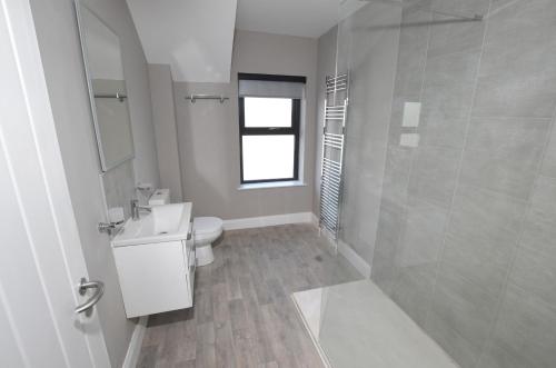 a bathroom with a toilet and a sink and a shower at Homestead Hillsborough Guest Rooms in Hillsborough