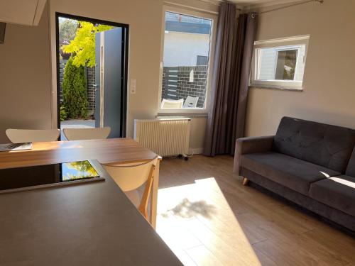 a living room with a couch and a table at Apartamenty i Domki WyDmy Międzywodzie in Międzywodzie