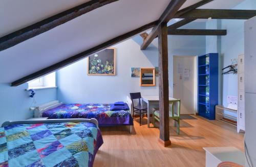 a attic room with a bed and a desk at Central Hostel in Rīga