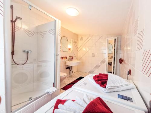 a white bathroom with a shower and a sink at Ferienwohnung Maris in Burghaun