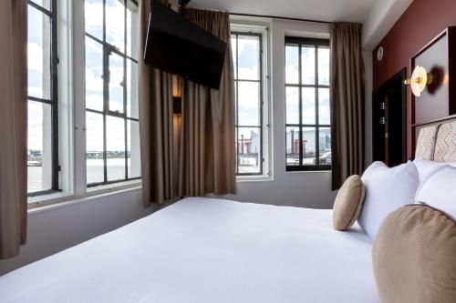 Ένα ή περισσότερα κρεβάτια σε δωμάτιο στο Hotel de Timmerfabriek I Kloeg Collection
