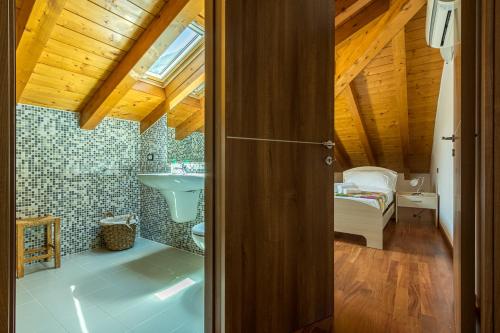 an open door to a bathroom with a sink at Apartment Maya - Tremezzina in Tremezzo