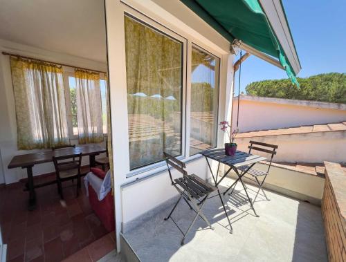 a patio with a table and chairs on a balcony at Azienda Agricola Sapereta in Porto Azzurro