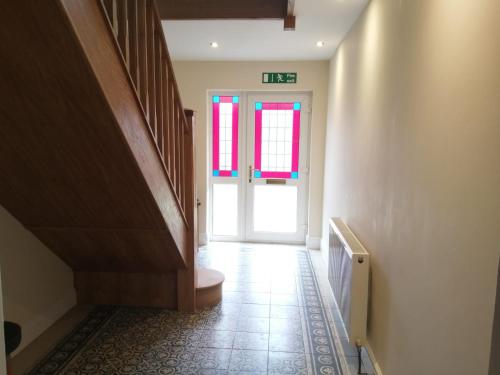 a hallway with a door and a toilet in a room at The Old School in Donington on Bain