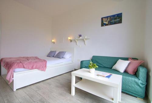 a living room with a bed and a couch at Studio apartments Kali in Kali