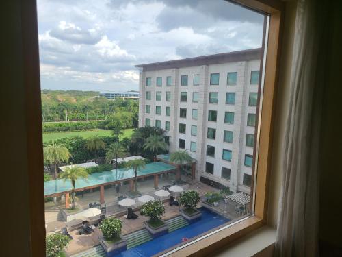 a view from a window of a hotel with a pool at Novotel Hyderabad Airport in Hyderabad