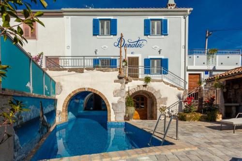 a house with a swimming pool in front of it at Villa Dunatić in Županje