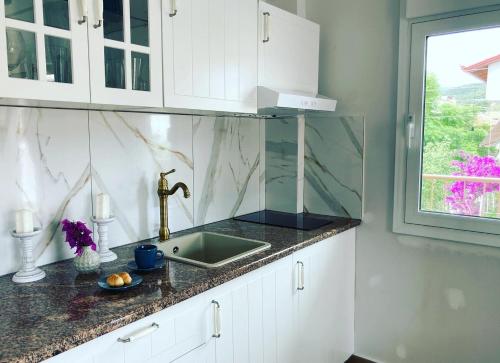 a kitchen with a sink and a window at Villa Ulyana Sarti - Ancient Greece in Center in Sarti