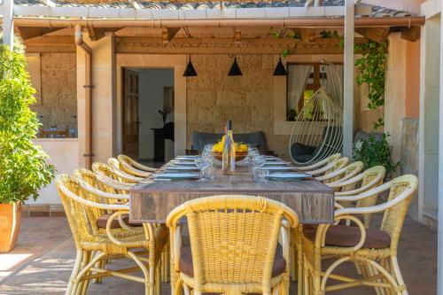 a wooden table and chairs on a patio at Pili in Felanitx