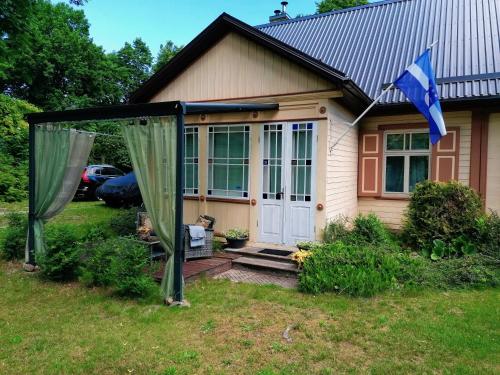 a house with a gazebo in front of it at Villa Irbe in Jūrmala