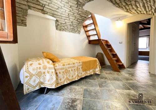 a bedroom with a bed and a staircase in a room at S’ammentu house in Bosa