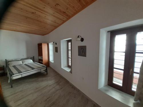 an empty room with a bed and a window at Mama's Home, Kallirachi Village in Kallirakhi