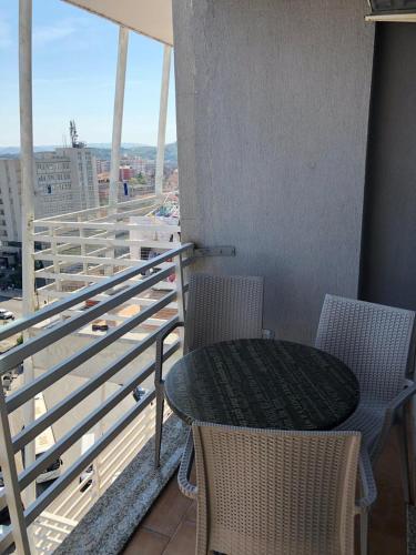 a table and chairs on a balcony with a view at VIEW APARTMENT in Shkodër