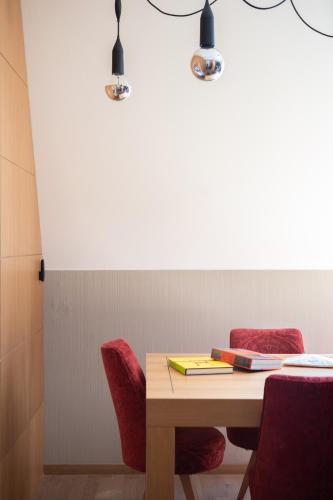 a table with two chairs and a book on it at INNSiDE by Meliá Prague Old Town in Prague