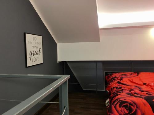 a bedroom with a bed with a red blanket at Banićević APARTMANI in Ðenovići